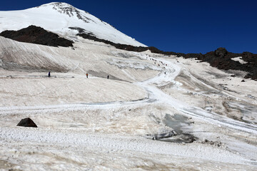 People Ascending Snowy Mount Elbrus