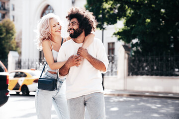 Smiling beautiful woman and her handsome boyfriend. Woman in casual summer jeans clothes. Happy...