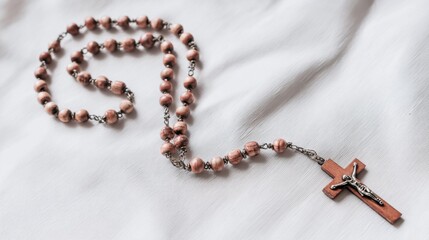 Catholic Rosary Beads with Wooden Cross on Soft White Fabric
