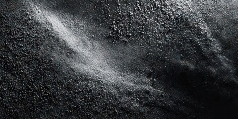 Dark chalk dust texture with scattered powder on black surface