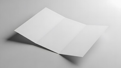 A white brochure lies open on a plain white surface, viewed from above, showcasing its empty pages and clean design.