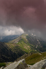 Beautiful alpine scenery, pristine glacier lake, rocks and spring flowers in the Transylvanian Alps in  early summer