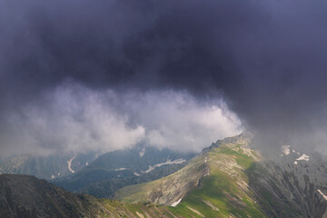 Beautiful alpine scenery, pristine glacier lake, rocks and spring flowers in the Transylvanian Alps in  early summer