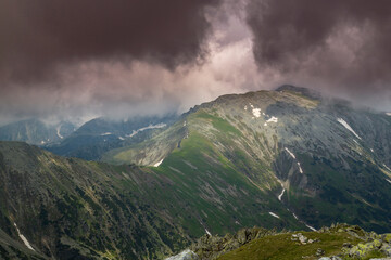 Beautiful alpine scenery, pristine glacier lake, rocks and spring flowers in the Transylvanian Alps in  early summer