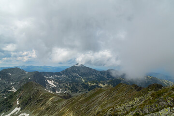 Beautiful alpine scenery, pristine glacier lake, rocks and spring flowers in the Transylvanian Alps in  early summer