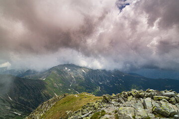 Beautiful alpine scenery, pristine glacier lake, rocks and spring flowers in the Transylvanian Alps in  early summer