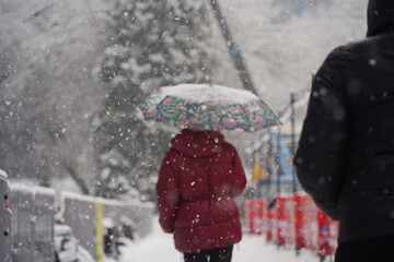 Almaty, Kazakhstan - 12.18.2025 : People are walking down the street in a heavy snowfall.