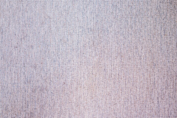 Closeup view of a rough linen fabric textile weave texture in neutral colors. Macro detail of canvas or cloth for background, wallpaper, or design