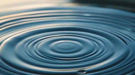 A macro shot of a clear blue water drop creating circular ripples on a clean liquid surface with a fresh splash and reflection - Powered by Adobe