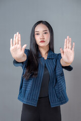 Serious Asian Woman Showing Raised Hands Gesture