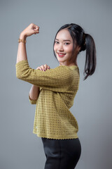 Confident Asian Woman Flexing Arm With Positive Energy
