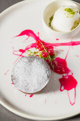 Warm chocolate lava cake with flowing center and powdered sugar