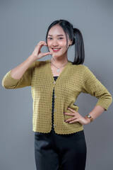 Smiling Asian Woman Making Hand Heart Gesture