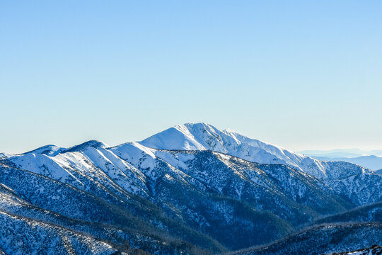 Mt Feathertop from Mt Hotham with blue sky and snow