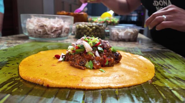 Low angle capturing the rich flavors and colorful ingredients of this cherished South American Venezuela holiday delicacy.. Traditional Food