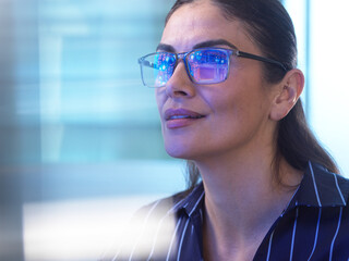 Engineer with glasses using artificial intelligence at workplace