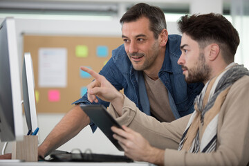 office man and colleague discuss about sales report