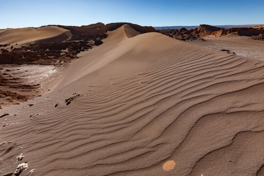 Sand dune and rock formations in Moon Valley desert landscape Chile