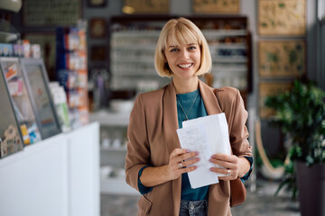 Portrait of happy woman in pharmacy looking at camera.