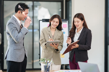 A group of Asian businessmen stood and discussed ways to solve investment business problems.