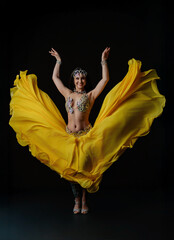 Woman performs dance with snake in colorful outfit during evening show