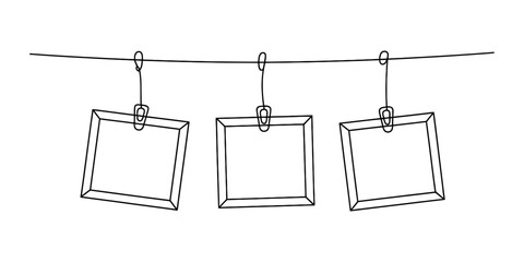 A hand-drawn sketch of three empty square picture frames hanging from a clothesline with clips Vector, illustration