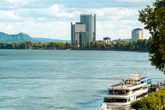 Bonn skyline with highrise tower and boats on the Rhine river in summer