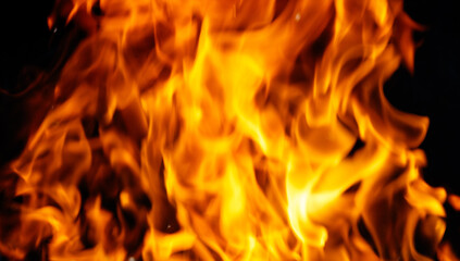 A close up of a large flame with a dark background