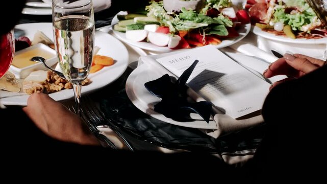 the waiter puts food on the guests' plates