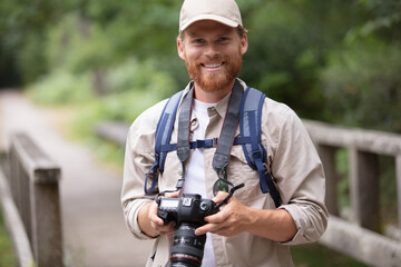 man wearing backpack holding a camera