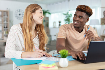mixed-race couple going over paperwork in the home