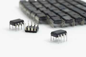 Close-up of integrated circuit IC chips on white background, symbolizing microelectronics, semiconductor manufacturing, hardware design, and electronic component technology.