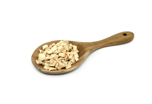 Pile of dried and sliced marshmallow root in a wooden spoon (Althaea officinalis) isolated on white background