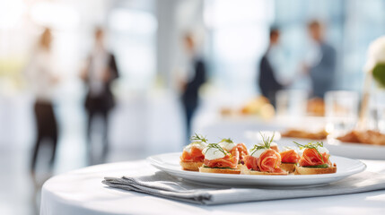 Gourmet salmon canapes served at sophisticated corporate event with blurred guests. Elegant salmon appetizers with cream cheese dill are presented on white plate at business reception
