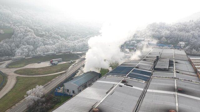Drone Shot of Steam From Cooling System of Metallurgical Factory Making Hear Frost on Landscape on Cold Winter Morning
