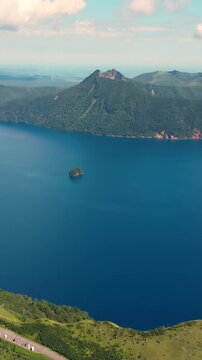 Vertical Aerial fly Lake Mashu Caldera in Japan Hokkaido Volcanic Lake, Misty Mountains, slow motion long exposure, Nature