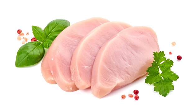 Sliced, raw, and pale pink poultry breasts are arranged on a white backdrop, alongside green basil and parsley sprigs, with peppercorns