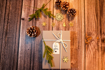 Christmas gift box and festive decorations creating a heartwarming holiday concept on wood
