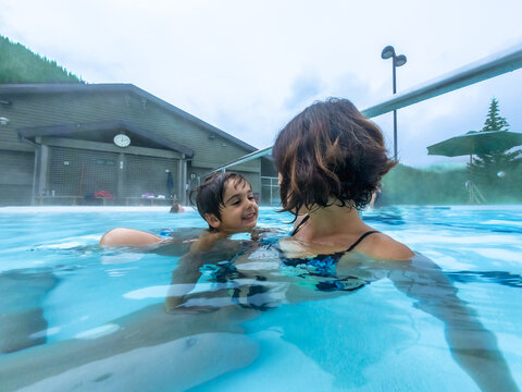 Mother and son enjoying hot spring in jasper national park, canada