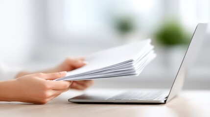 Accountant reviewing financial documents while seated at a desk with a laptop, showcasing a professional workspace and organized paperwork for efficient financial management
