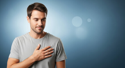 Man with hand on chest against blue background. Blue background man showing gratitude with hand over heart, conveying sincerity. Use this blue background man image to express November themes.