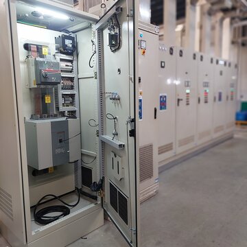 This image shows an Industrial Electrical Control Panel, likely located in a factory or a power plant.