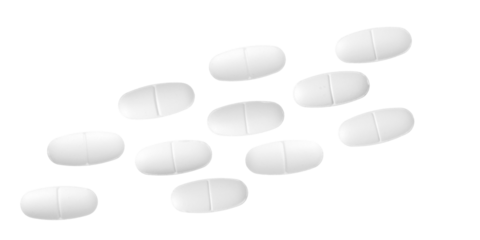 high-angle photograph of group of white oval pills with a central score line, laid out on a dark background for medical and pharmaceutical concepts