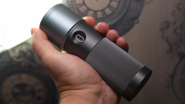 a flashlight for a photographer and videographer in hand