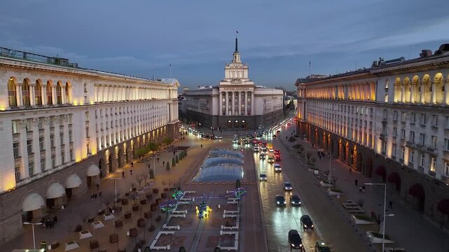 Aerial night view of capital of Bulgaria Sofia. Three architectural and iconic buildings of the communist era. Council of Ministers, Presidency and Party home Current Parliament building. Backward. 4К