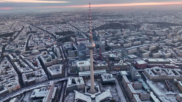 City of Berlin, Germany from above. Aerial winter cityscape view at sunrise or sunset, showing architectural landmarks Oberbaum Bridge, TV Tower and Berlin Cathedral in winter. 