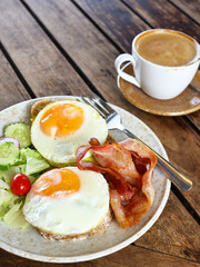 traditional breakfast with fried egg and salad