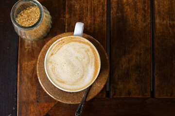 cup of cappuccino on wooden table for coffee break