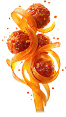 Skewered, spiced meatballs adorn curled, colorful vegetable ribbons