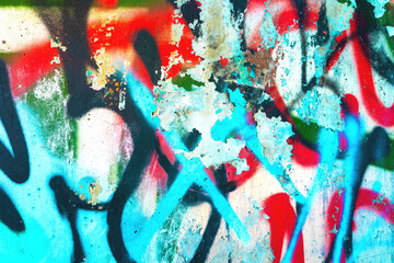Graffiti abstract texture in red, blue, black with peeling paint. Urban street style, 2000s, Y2K aesthetic, fluorescent colors, rough surface. Background, texture, digital art, creative banner, web.